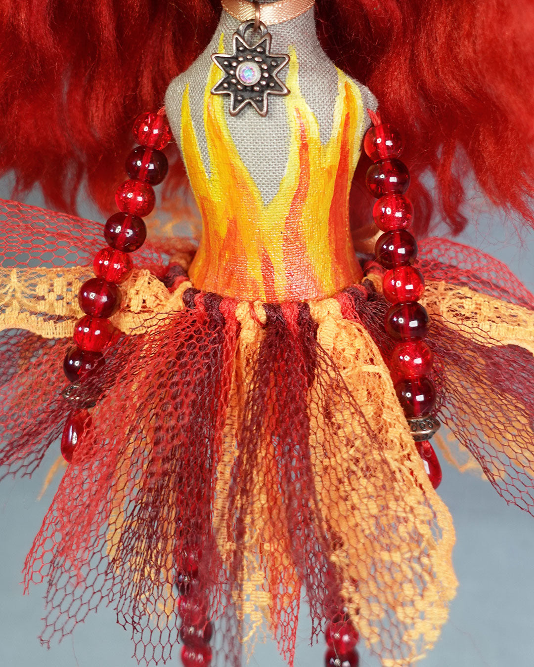 close up of painted flames on doll torso