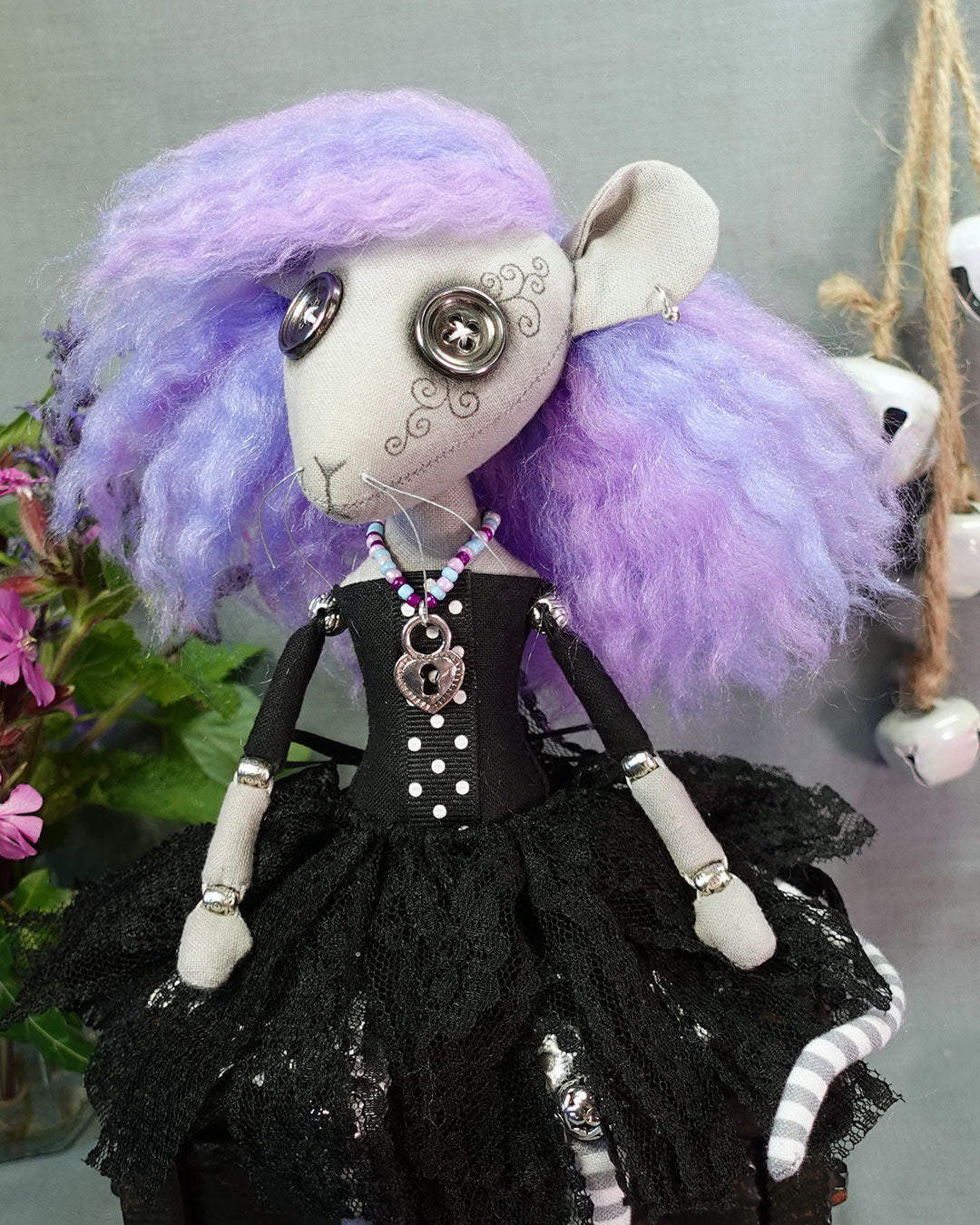 a goth rat girl art doll with button eyes, pastel hair, black dress with tattered lace skirt, and heart shaped lock necklace