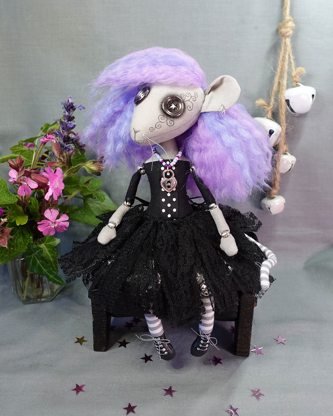a goth rat girl art doll with button eyes, pastel hair, black dress with tattered lace skirt, and lace up boots