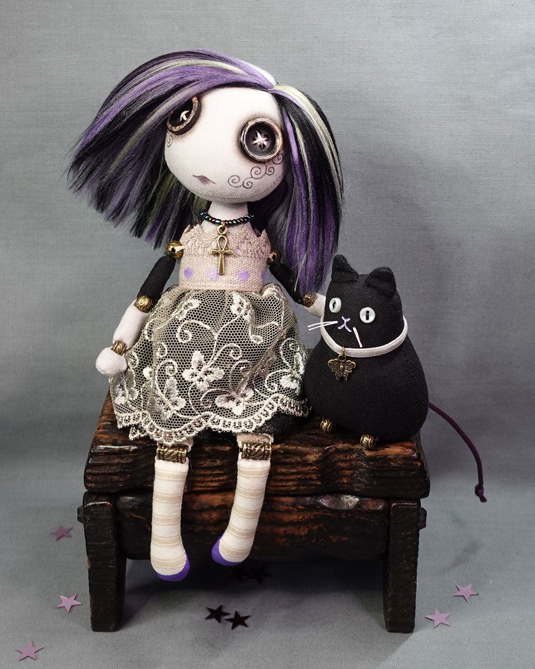 a button eyed girl doll with black cat