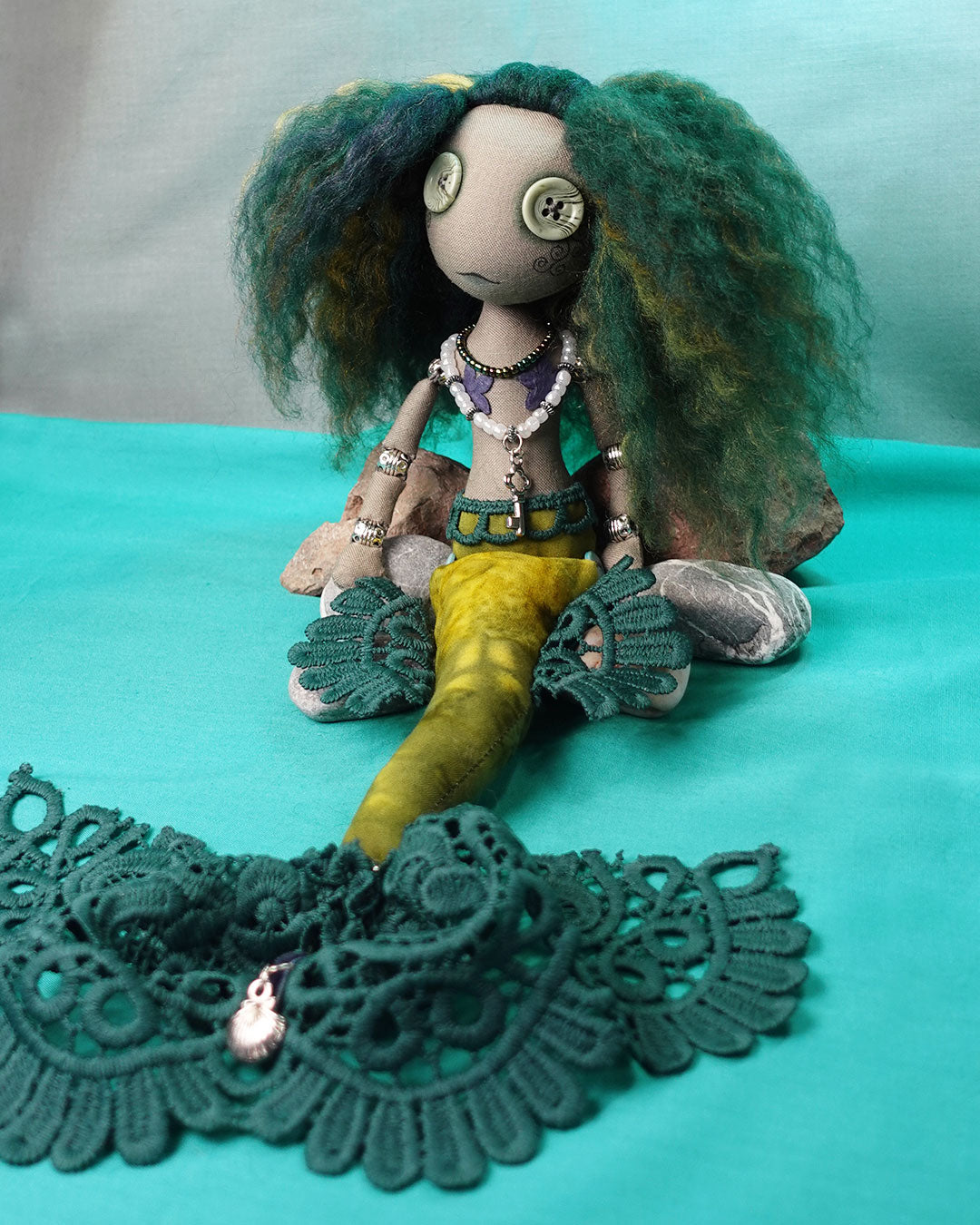 a button eyed mermaid doll with green hair