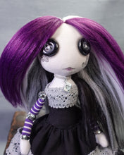 close up of a button eyed, cloth art doll in Ace flag colours, black, grey, white and purple