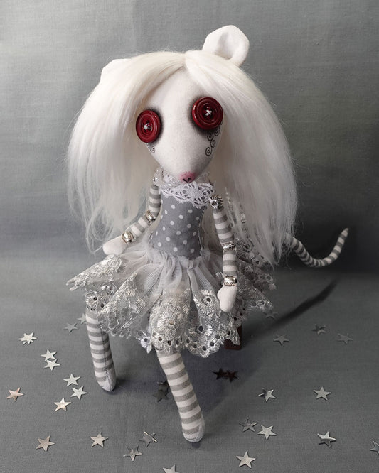 an albino rat cloth art doll with red button eyes and long white hair