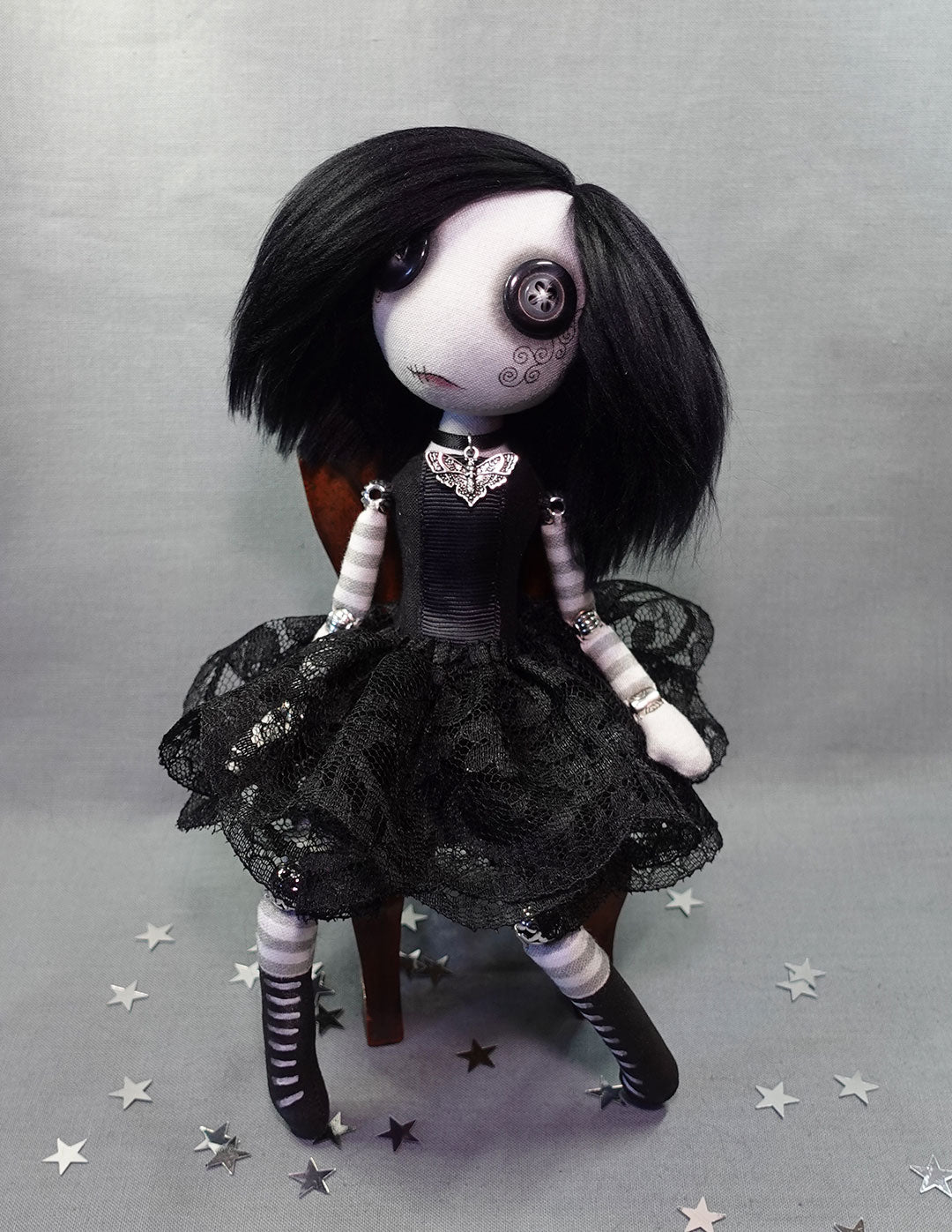 a button eyed cloth goth girl art doll in black dress with moth necklace