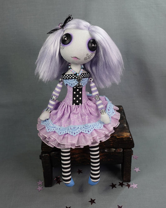 a button eyed cloth art doll with pastel lavender hair in pastel goth dress