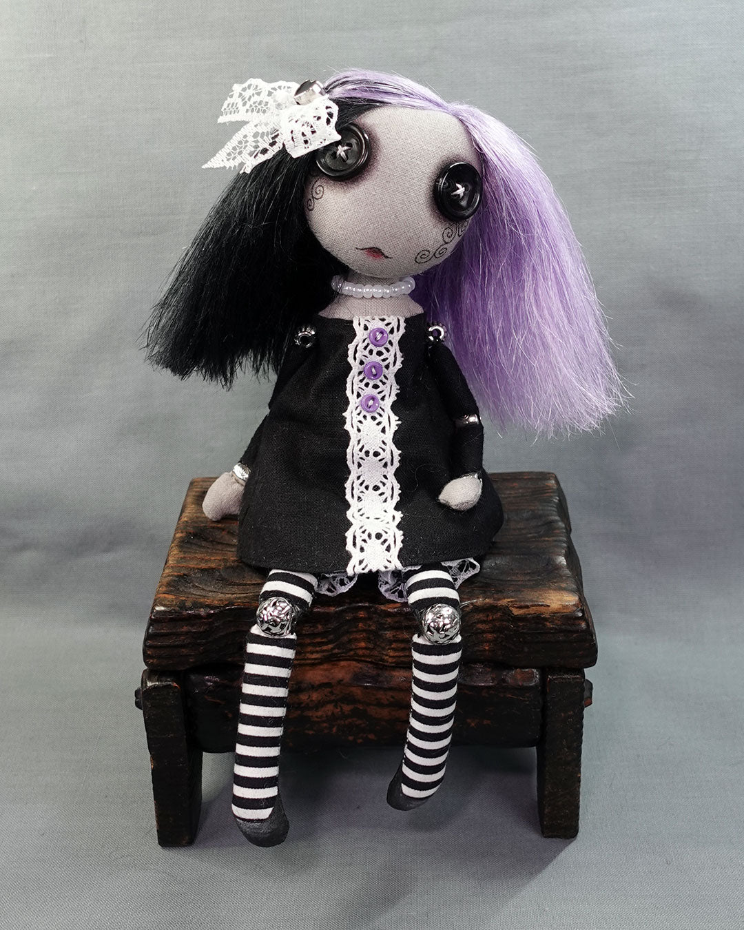 a button eyed gothic cloth art doll with purple and black hair