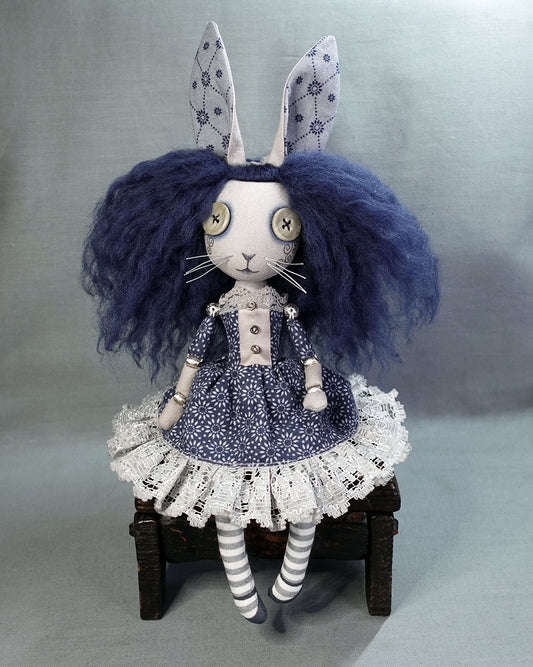 a cloth rabbit girl art doll with button eyes and blue hair