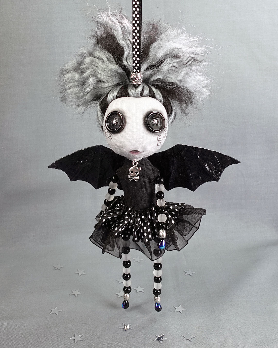a Gothic fairy art doll with button eyes, bat wings and glass beaded arms and legs