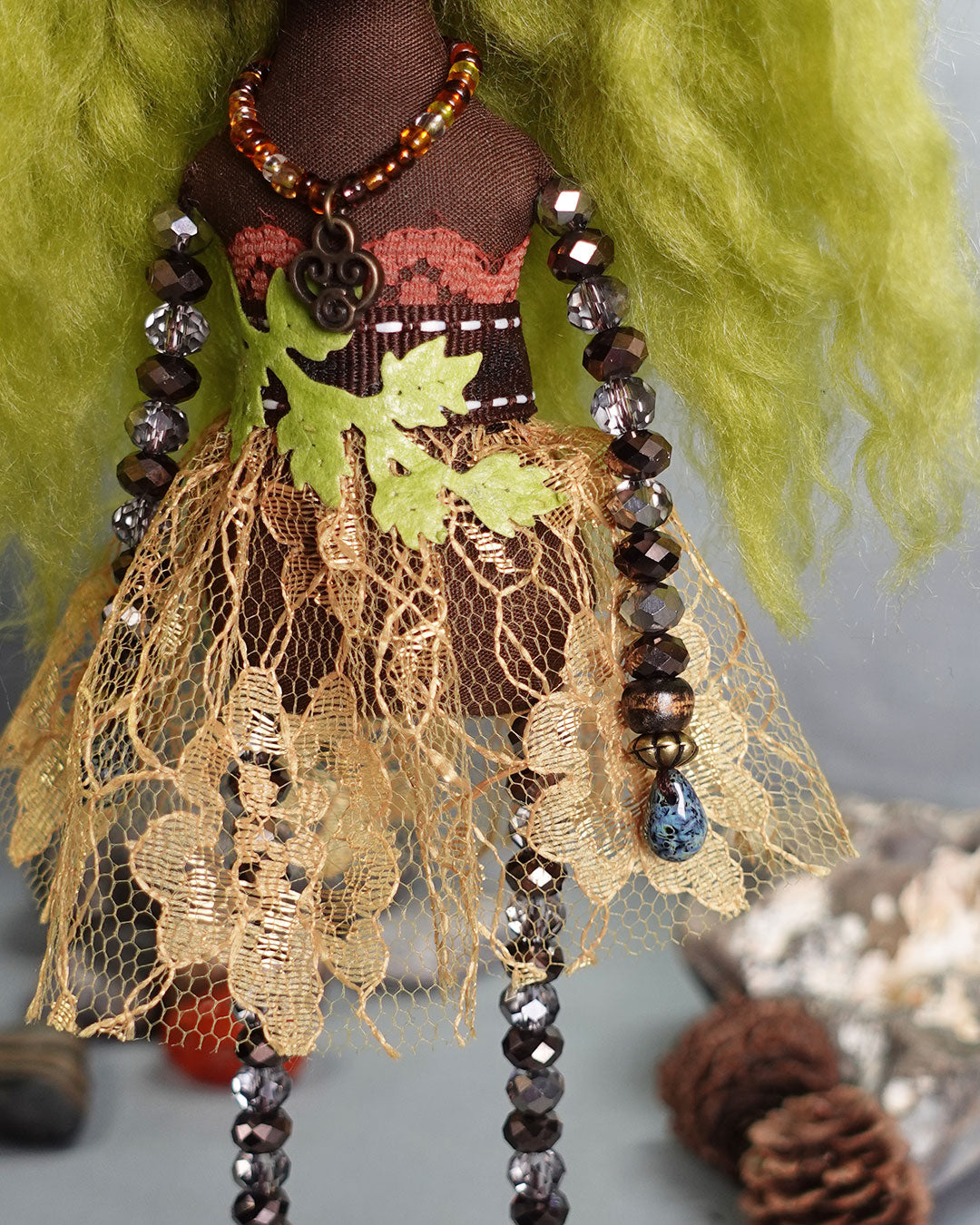 close up of doll dress and beaded limbs