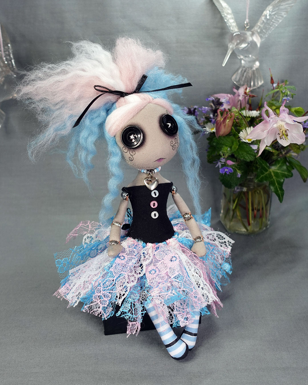 a button eyed cloth art doll in trans flag colours