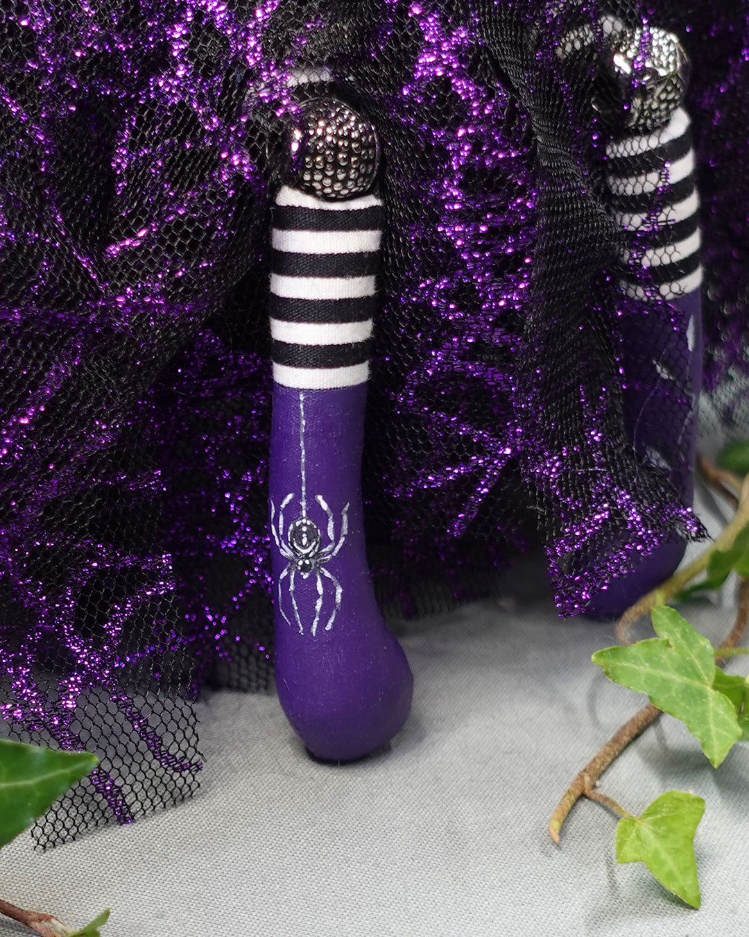 close up of purple boot with hand painted spider design