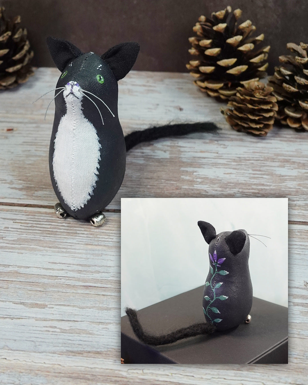 Black and white cat figurine with a close-up inset on a wooden surface with pinecones.