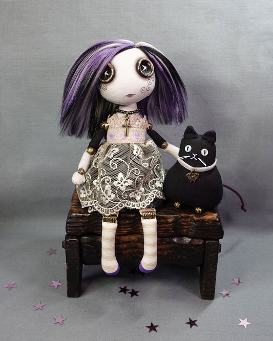 a button eyed girl doll with black cat