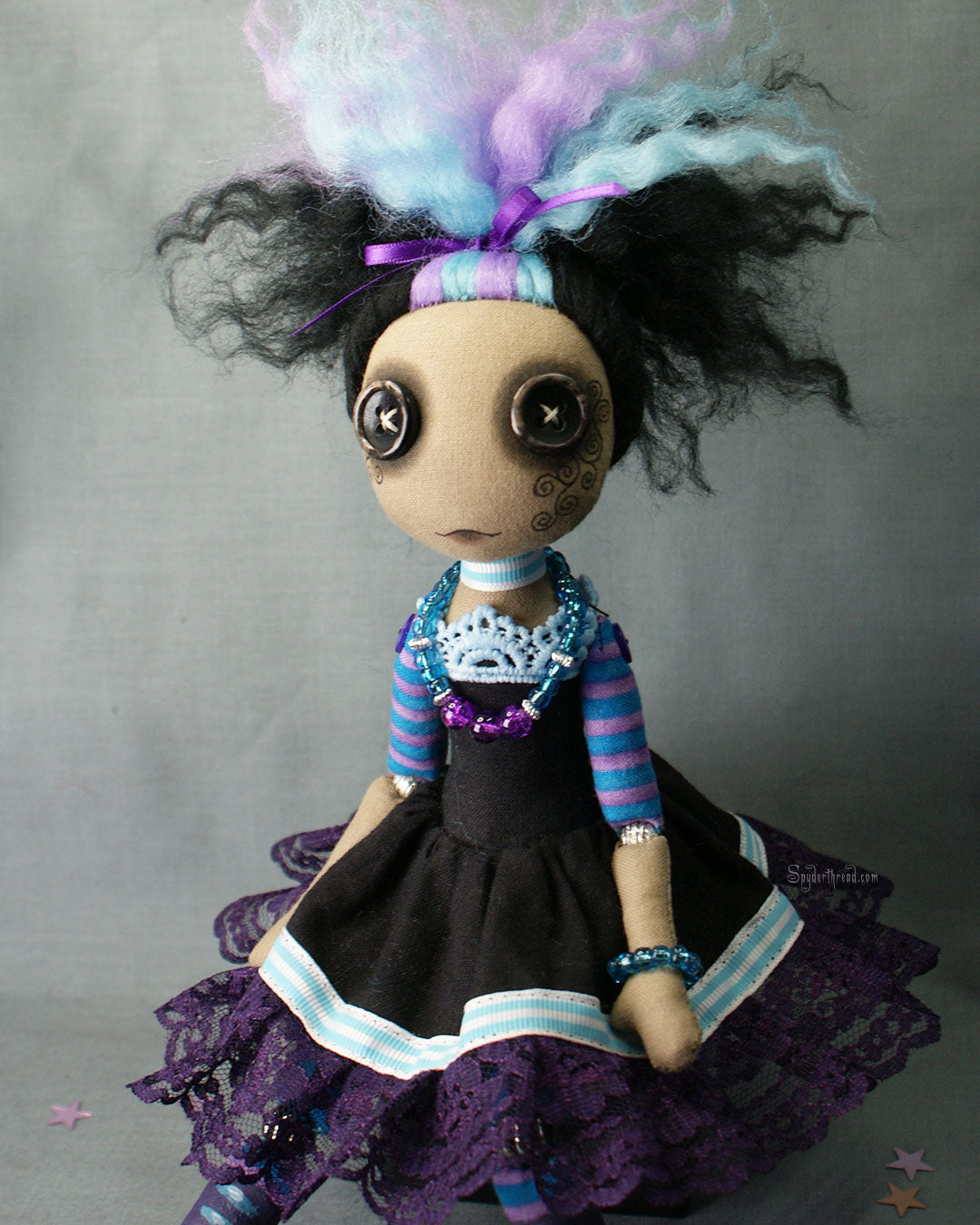 BAME brown skin tone button eyed Gothic style doll in black purple and blue dress with purple lace up boots